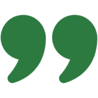 Green quote symbols on dark backdrop